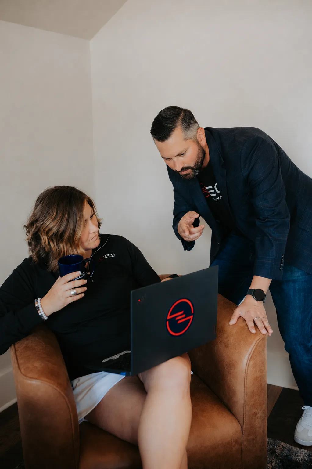 An ECS advisor reviewing technology with a team member