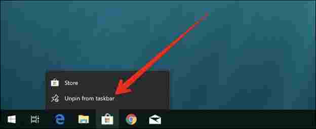 A computer screen with a red arrow pointing to a taskbarDescription automatically generated with low confidence